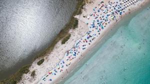 an overhead view of a beach with people in the water at Residence Hotel Lu Nibareddu in San Teodoro