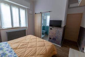 Łóżko lub łóżka w pokoju w obiekcie Il giardino di Fiorina