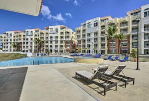 un complejo con piscina, tumbonas y edificios en Heavenly Aguadilla Condo with Infinity Pool and Views!, en Aguadilla
