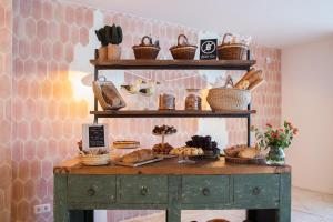 a table with baskets and pastries on it at The 15th Boutique Hotel by Bondia Group in Lloret de Mar