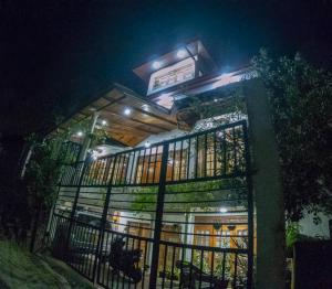 a building with a fence in front of it at night at Innovick Residence in Kandy