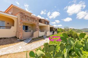 a villa with a view of a house at Residence Hotel Lu Nibareddu in San Teodoro