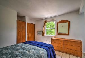 a bedroom with a bed and a dresser and a mirror at Breezy Condo with Balcony Less Than 2 Mi to Downtown Culebra in Culebra
