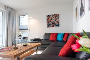 a living room with a couch and a table at Terrassenwohnung "Kliffgarten" - Oase am Haff in Garz-Usedom