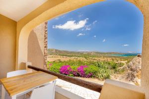 a view from the balcony of a house with a table and chairs at Residence Hotel Lu Nibareddu in San Teodoro