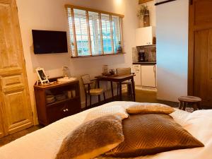 een slaapkamer met een bed en een keuken met een tafel bij B&B Zen in Lage Zwaluwe