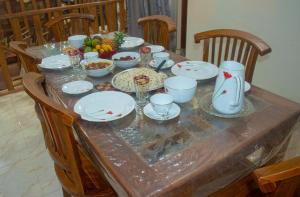 a table with plates and bowls of food on it at Innovick Residence in Kandy