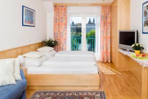 sala de estar con 2 camas y ventana en Gästehaus Plank, en Graz