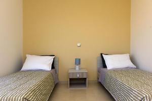 A bed or beds in a room at Stelia Luxury apartments