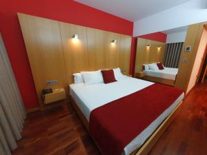 Postel nebo postele na pokoji v ubytování Hotel Dunas d'Ovar