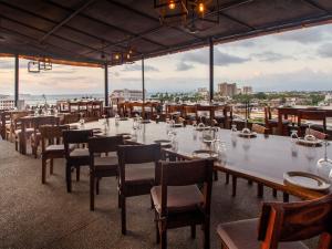 a large dining room with a long table and chairs at Hotel Paloma del Mar in Puerto Vallarta