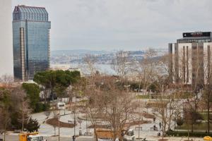 a park in a city with a tall building at Taksim Square Apartment, Great View, Luxury in Istanbul