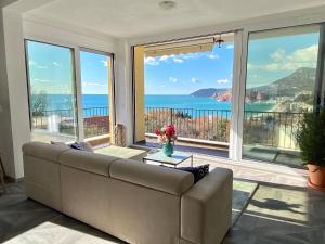 a living room with a couch and a view of the ocean at Villa Casanego in Sutomore