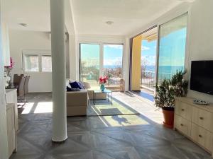 a living room with a couch and a television at Villa Casanego in Sutomore
