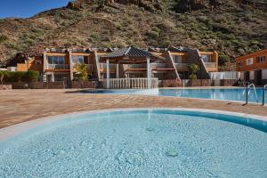 a large swimming pool in front of a house at Villa Gisel in La Playa de Tauro