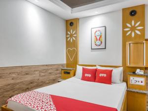 1 dormitorio con 1 cama con almohadas rojas en OYO Estrela Dalva, São Paulo, en São Paulo