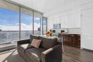 a living room with a couch and a kitchen at SOHO Residences Lisgar in Ottawa