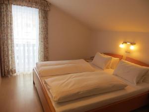 Postel nebo postele na pokoji v ubytování Garni Haus Jagerwirt