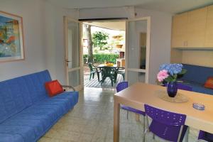 a living room with a blue couch and a table at Tivoli in Bibione