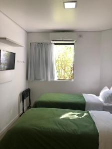 Postel nebo postele na pokoji v ubytování Anhembi Hostel