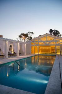 a swimming pool in the middle of a house at Playas Art Hotel in Pinamar