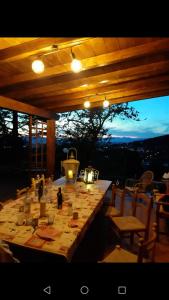 a long table in a pavilion with chairs and a tableablish at La Casetta di Ross in Castellina Marittima