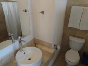 a bathroom with a white sink and a toilet at Casa Maru Hotel in Parras de la Fuente +24 photos