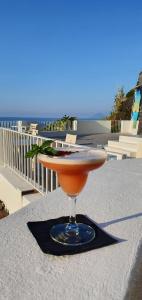 a drink sitting on a table with the ocean in the background at Hotel Santa Isabel in Malfa