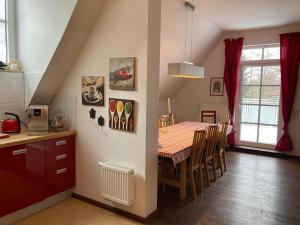 a kitchen and dining room with a table and chairs at Auberge Tabarz Inselsberg in Tabarz