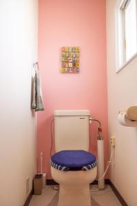 a bathroom with a toilet with a blue seat at Maeda Forestry House - Vacation STAY 19184v in Furano