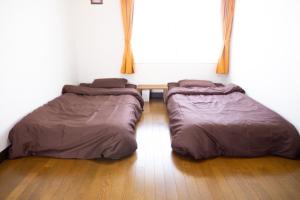 two beds sitting on the floor in a room at Maeda Forestry House - Vacation STAY 19585v in Furano