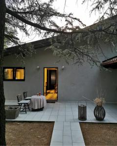 a patio with a table and a dining room at MilBor Fruška Gora in Novi Sad