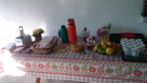 a table with a table cloth with fruit on it at Pousada Camping Bombinhas in Bombinhas