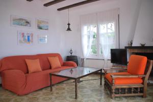 a living room with a couch and a coffee table at Es Caials in Cadaqués