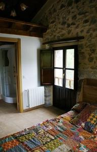 A bed or beds in a room at El Pontarron Apartamentos