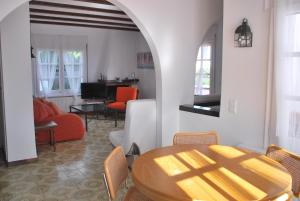 a living room with a wooden table and a living room at Es Caials in Cadaqués