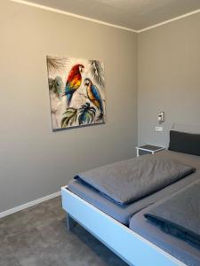 a bedroom with a bed and a painting on the wall at Hotel Kellermann in Overath