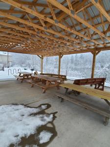 a group of picnic tables in a pavilion in the snow at Endless Mountain Adventure in Renovo