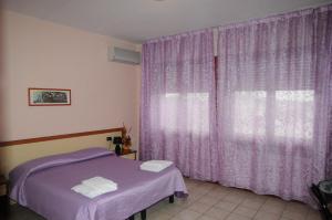 Postel nebo postele na pokoji v ubytování Hotel Cippa’s