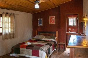 um quarto com uma cama e um tecto de madeira em Espaço João Mineiro em Tiradentes