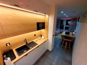 a kitchen with a sink and a table in a room at Na górze 23 in Szklarska Poręba