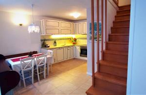 a kitchen with a table and a kitchen with a staircase at Casa Mattea in Nerezine