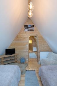 a attic bedroom with two beds and a ceiling at U Leona in Gorlice