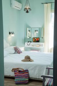 a bedroom with a bed with a hat on it at 7 Brothers Hotel in Poros