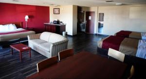 a hotel room with a bed and a couch at Econo Lodge Inn & Suites in Kearney