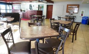 a dining room with wooden tables and chairs at Econo Lodge Inn & Suites in Kearney