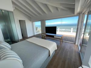 1 dormitorio con cama y vistas al océano en Terrazas Al Mar en Pinamar
