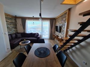 a living room with a table and a couch at Starloft Kopaonik in Kopaonik