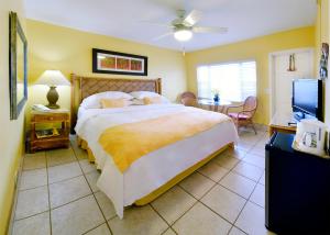 a bedroom with a large bed and a television at Tropic Seas Resort in Fort Lauderdale