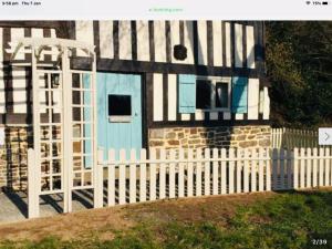 a house with a white fence and a blue door at Maison Mai or La Petite Maison Mai or La Petite Grange or ALL three in La Chapelle-Urée